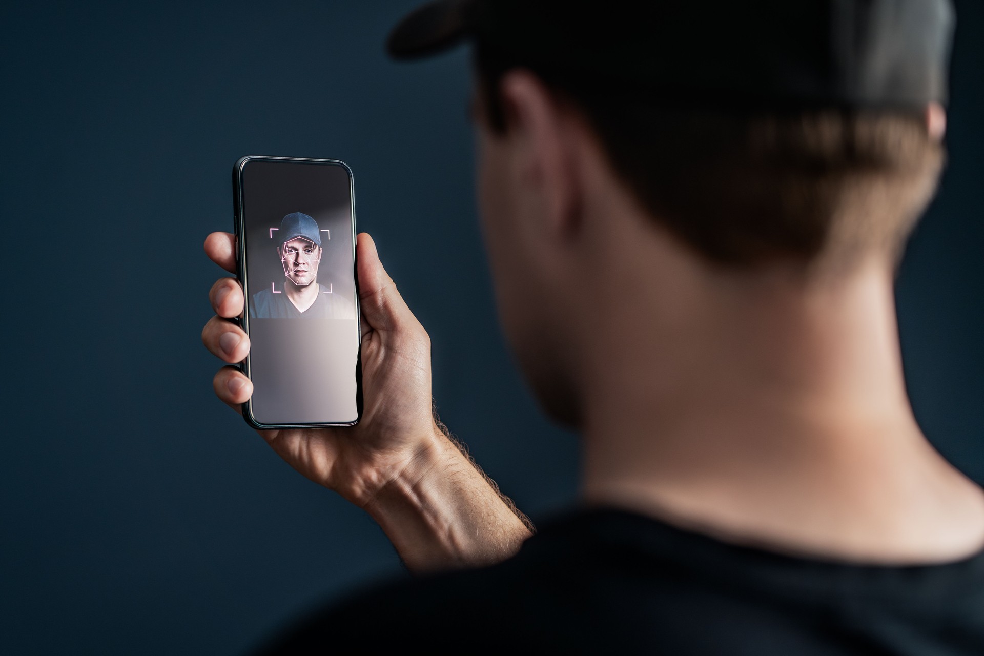 Face recognition with facial scan in phone. Identification and verification to unlock smartphone. Deep fake technology. Man using cellphone. AI mobile tech and biometric id authentication.